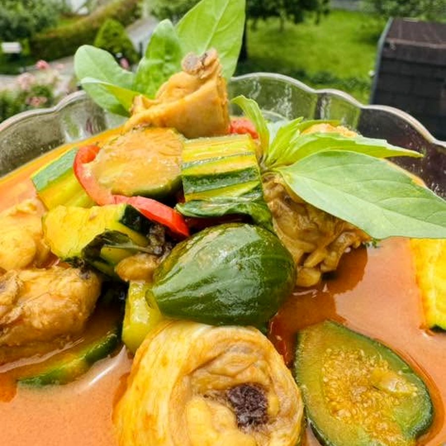 A Thai red curry plated, Europe in the background